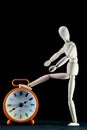 wooden dummy and analogic clock, time concept, puppet made of wood, art mennequin.Wooden Doll