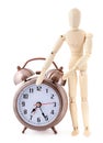 Wooden dummy with old-styled alarm clock Royalty Free Stock Photo