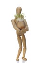 Wooden dummy and pot with cuckooflower Royalty Free Stock Photo