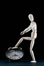 wooden dummy and analogic clock, time concept, puppet made of wood, art mennequin.Wooden Doll