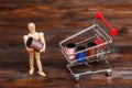Wooden dummy puppet and mini shopping cart with thread spools