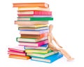 Wooden dummy puppet sitting on books Royalty Free Stock Photo