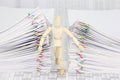Wooden dummy try to escape from dual pile overload document Royalty Free Stock Photo