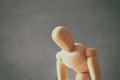 wooden dummy with worried stressed body position