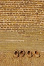 Wooden Dutch clogs outside of windmill house wall