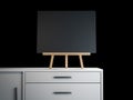 Wooden easel with black blank frame. 3d rendering Royalty Free Stock Photo