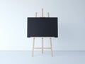 Wooden easel with blank black canvas. 3d rendering Royalty Free Stock Photo
