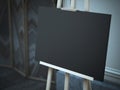 Wooden easel with a blank black canvas on the street. Royalty Free Stock Photo