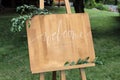 Wooden easel with a board. On the board written white paint - Welcome Royalty Free Stock Photo