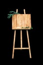 Wooden easel with a board. On the board written white paint - Welcome. Isolation on a black background Royalty Free Stock Photo