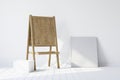Wooden easel standing in an empty white room. 3d rendering Royalty Free Stock Photo