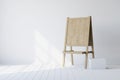 Wooden easel standing in an empty white room Royalty Free Stock Photo