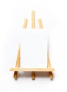 wooden easel with white paper ready for new painting, space for your text, message or promo ad