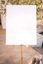 Wooden easel with white paper