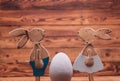 Wooden easter bunnies facing each other near big egg Royalty Free Stock Photo