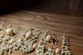 Wooden easter eggs among flowering cherry branches on a rustic table. symbolic composition of the spring holiday for a gift card.