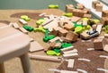 Wooden eco friendly block toys scattered on floor in kids room. Messy nursery children room Royalty Free Stock Photo