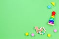 Wooden educational baby toys on light green background. Top view Royalty Free Stock Photo