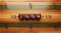 Wooden educational board with math fraction cubes arranged in a line showing basic arithmetic operations on a natural wood Royalty Free Stock Photo