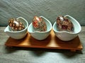 wooden egg display on a table with an Indonesian batik motif. Placed on a wooden table