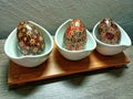 wooden egg display on table with Indonesian batik motif. Placed on a wooden table.