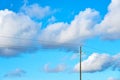 Wooden electric pole under a blue sky. Royalty Free Stock Photo