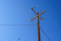 Wooden electrical pole with wires and clear blue sky Royalty Free Stock Photo