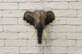 Wooden elephant head hanging on a white brick wall Royalty Free Stock Photo