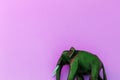 Wooden elephant on violet background