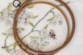 Wooden embroidery hoop with fragment of a colorful cross-stitch embroidery, flower ornament Royalty Free Stock Photo