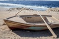 Wooden empty boat with two oars on beach Royalty Free Stock Photo