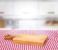 Wooden empty cutting board on picnic cloth background. Royalty Free Stock Photo