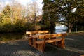 Wooden empty picnic table in a park by pondside in Emsland, Meppen, Germany