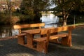 Wooden empty picnic table in a park by pondside in Emsland, Meppen, Germany