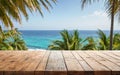 wooden empty table with palm trees and ocean view