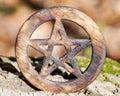 Wooden encircled pentagram symbol on fibrous tree bark. Five elements: Earth, Water, Air, Fire, Spirit.