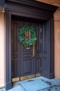 The entrance door is decorated with a Christmas wreath Royalty Free Stock Photo