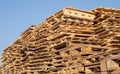 Wooden euro pallets for transfering goods to customers. Used wooden pallets in stack in the warehouse. Wooden pallet
