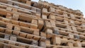 Wooden euro pallets for transfering goods to customers. Used wooden pallets in stack in the warehouse. Wooden pallet overlap