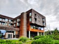 Wooden facade Baltic seaside resort building in Sopot surrounded with green garden during cloudy weather