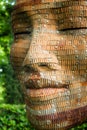 Wooden face sculpture with riveted eyes