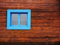 Wooden textured farmhouse wall and a blue framed window Royalty Free Stock Photo