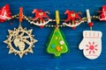 Colorful Christmas decorations and Christmas lights on a rope on the blue wooden background. Royalty Free Stock Photo