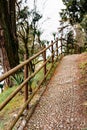 Wooden fence along the cobbled path in the garden. Villa Monastero, Italy Royalty Free Stock Photo