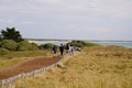 Wooden fence along pedestrian path seacoast in Vendee family behind walk