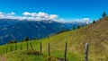 Gurglitzen - Wooden fence on alpine meadow with Panoramic view of mountain peaks of Karawanks and Julian Alps Royalty Free Stock Photo