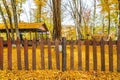 Wooden fence in the autumn forest. Camping place Royalty Free Stock Photo