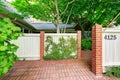 Wooden fence with brick columns and tile floor front yard Royalty Free Stock Photo