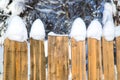 Wooden fence covered with white thick snow Royalty Free Stock Photo