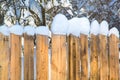 Wooden fence covered with white thick snow Royalty Free Stock Photo